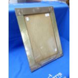 An Arts & Crafts silver-plated rectangular photo / picture frame, with hammered decoration, formerly