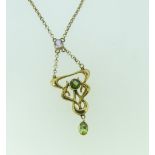 A 9ct yellow gold Art Nouveau Pendant, the centre and drop with small peridot and with a pale