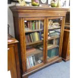 A late Victorian oak Bookcase, the rectangular top with moulded cornice above two glazed doors