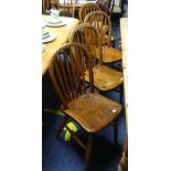 A set of four early 20thC ash and elm Windsor-style stick back Chairs, including two stamped '
