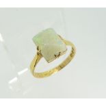 A Victorian opal Ring, the rectangular opal in four claw setting, chip to one corner, all in 18ct