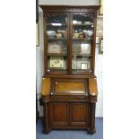 An Art Nouveau-style oak Bureau Bookcase, with the two large glazed doors enclosing three mobile