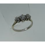 A small graduated three stone diamond Ring, mounted in 18ct white gold, Size O.