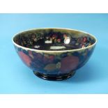 A Moorcroft 'Pomegranate' pattern Fruit Bowl, with green glaze and impressed marks to the base, 8¼in