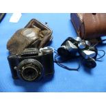 An early French Eljy Lumiere Sub Miniature Camera, with leather 'purse' case, 3in (7.5cm) wide,