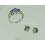 A small graduated three stone tanzanite Ring, mounted in 10k white gold, together with a pair of