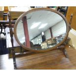 An Edwardian mahogany oval Wall Mirror, a bevelled edge plate enclosed with an inlaid banding of