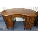 An Edwardian mahogany kidney-shaped Desk, the kidney-shaped with leatherette inset top, enclosed