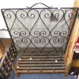 A wrought iron Spark Guard, 24in (61cm) wide x 26in (66cm) high, together with an antique cast