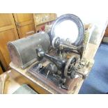 Two Vintage Sewing Machines; a Singer with domed wooden cover, the other by Serata, both a/f,