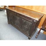 A 17th century and later oak Coffer, the associated plain hinged lid above three carved panels, on