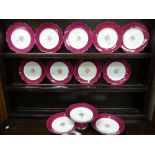 A small Coalport Dessert Service, with a central floral design enclosed by pink and gold borders and