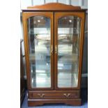 A late 20thC mahogany mirror-backed Glazed Cabinet, with two doors enclosing three glazed shelves,
