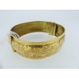 An 18ct yellow gold Hinged Bangle, with foliate engraved decoration, Swedish hallmarks for 1944,