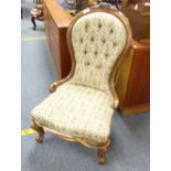 A Victorian walnut-framed Nursing Chair, the spoon-back shape enclosing the button-back