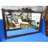 An early 20th century walnut framed rectangular Wall Mirror, with carved scroll decoration and