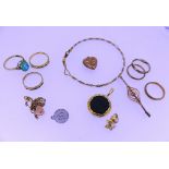 A quantity of Mixed Gold, including three 9ct rings, a small heart shaped locket in 9ct, a broken