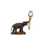AN EARLY 20TH CENTURY GERMAN PATINATED AND GILT METAL SWINGING PENDULUM CLOCK MODELLED AS AN ELEPHAN
