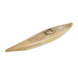 AN INUIT CARVED WALRUS IVORY MODEL OF A CANOE
