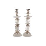 A PAIR OF ROCK CRYSTAL AND SILVERED METAL CANDLESTICKS