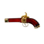 A LATE 19TH CENTURY FRENCH CRANBERRY GLASS AND GILT METAL SCENT BOTTLE MODELLED AS A PISTOL