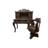 A FINE LATE 19TH CENTURY MEIJI PERIOD JAPANESE EXPORT CARVED HARDWOOD DESK AND CHAIR EXHIBITED AT TH