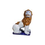 A LARGE 20TH CENTURY FAIENCE ROUEN-STYLE MODEL OF A LION