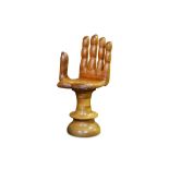 A 1960'S CARVED HARDWOOD SWIVEL CHAIR MODELLED AS A GIANT HAND