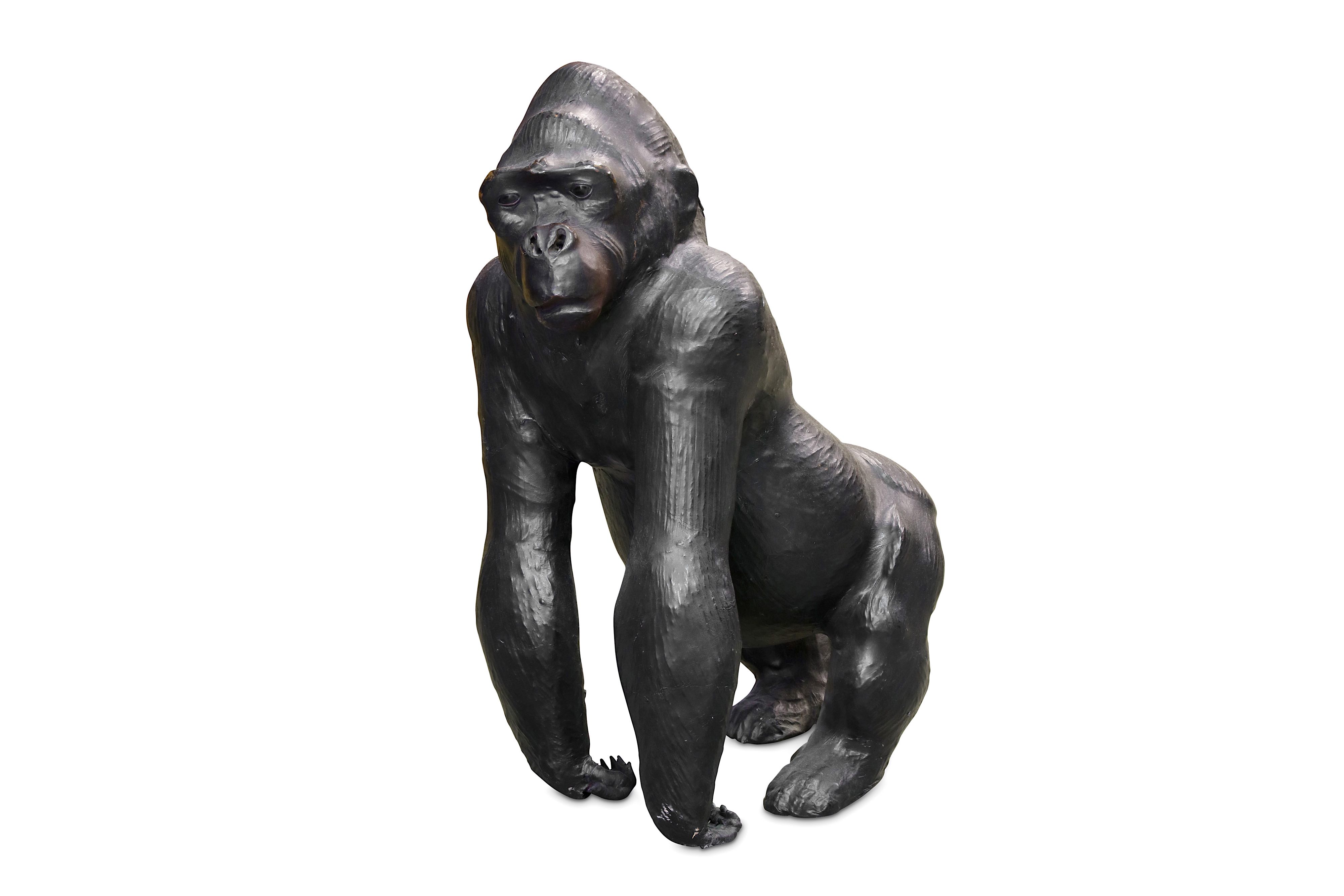 A MID 20TH CENTURY LEATHER COVERED MODEL OF A GORILLA