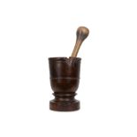 A LARGE 17TH / 18TH CENTURY CARVED WOOD MORTAR WITH ASSOCIATED PESTLE