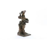 A BRONZE FIGURINE OF AN ITINERANT MAGIC LANTERNIST