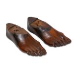 TREEN: A PAIR OF 19TH CENTURY CARVED FRUITWOOD RIGHT FEET