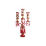 A  late 19th century Bohemian ruby glass centerpiece, of Persian design, the three storm shades