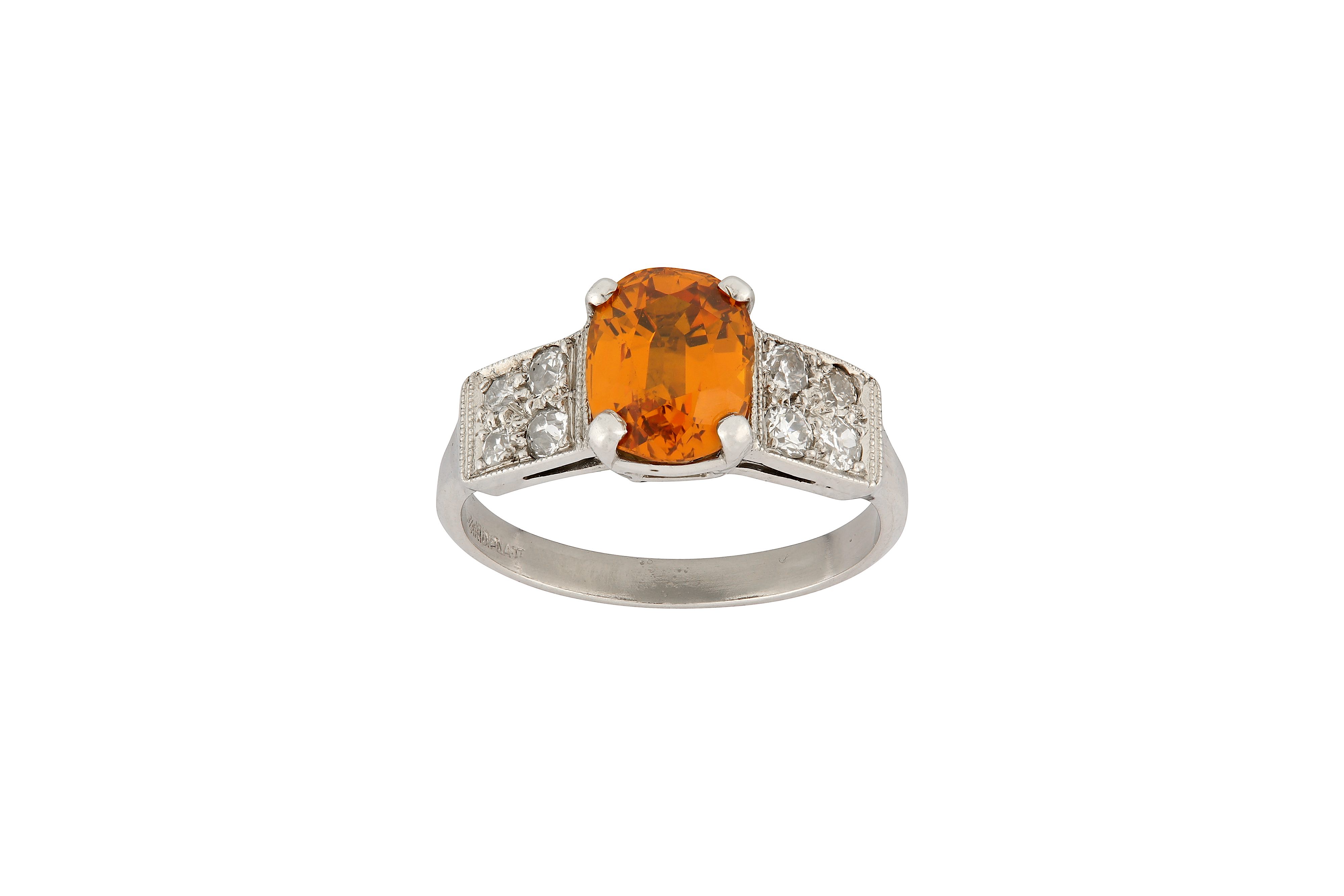 An orange sapphire and diamond ring