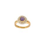 A purple star sapphire and diamond cluster ring