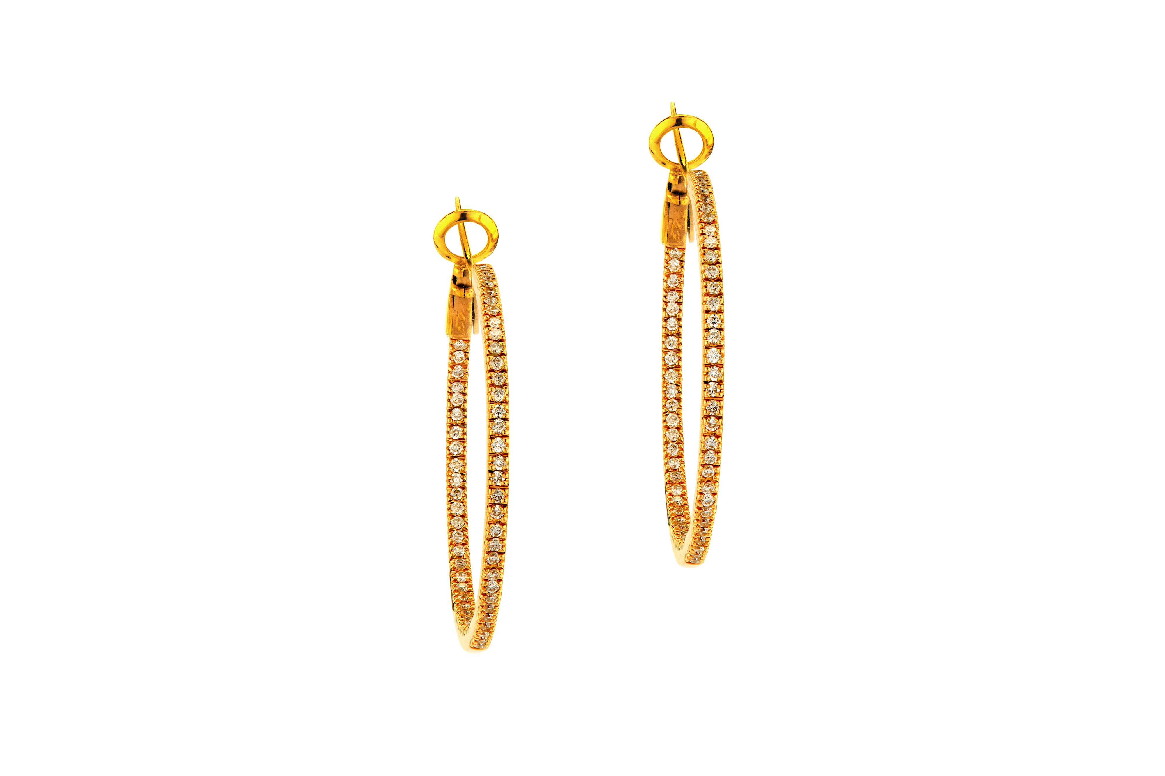 A pair of gold and diamond hoop earrings