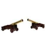 A GOOD PAIR OF 19TH CENTURY BRONZE MODELS OF CANNONS with tapering bronze barrels and raised on