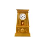 AN EARLY 19TH CENTURY FRENCH EMPIRE PERIOD GILT BRONZE MANTEL CLOCK IN THE EGYPTIAN REVIVAL STYLE