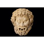AN 18TH CENTURY ITALIAN CARVED MARBLE FOUNTAIN HEAD DEPICTING A BEARDED SATYR with thick curly