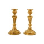 A PAIR OF LATE 19TH CENTURY FRENCH GILT BRONZE CANDLESTICKS IN THE LOUIS XVI STYLE formed as