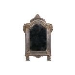 A SMALL 18TH CENTURY ITALIAN BAROQUE STYLE SILVERED BRASS MIRROR the toilette mirror of arched form,