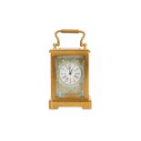 A GILT BRASS AND PORCELAIN MOUNTED MINIATURE CARRIAGE CLOCK