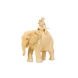 AMENDED - AN EARLY 20TH CENTURY JAPANESE CARVED IVORY OKIMONO OF AN ELEPHANT AND RIDER