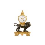 A LATE 19TH CENTURY FRENCH GILT AND PATINATED BRONZE MANTEL CLOCK MODELLED WITH A LION in the