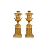 A PAIR OF SECOND QUARTER 19TH CENTURY FRENCH GILT AND SILVERED BRONZE CANDLESTICKS FORMED AS URNS