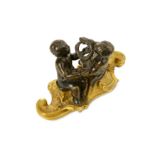 A MID 18TH CENTURY FRENCH BRONZE FIGURAL GROUP OF TWO PUTTI PLAYING WITH A WREATH mid to dark