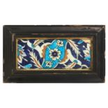 A 17TH CENTURY TURKISH OTTOMAN IZNIK GLAZED POTTERY TILE of rectangular form, decorated with blue,