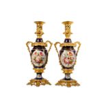 A PAIR OF SEVRES STYLE PORCELAIN AND GILT METAL MOUNTED LAMP BASES of twin handled form, the
