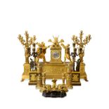 A LARGE AND IMPRESSIVE 19TH CENTURY FRENCH EMPIRE STYLE GILT BRONZE CLOCK GARNITURE DEPICTING THE