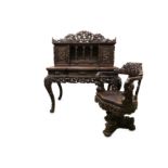 A FINE LATE 19TH CENTURY MEIJI PERIOD JAPANESE EXPORT CARVED HARDWOOD DESK AND CHAIR EXHIBITED AT